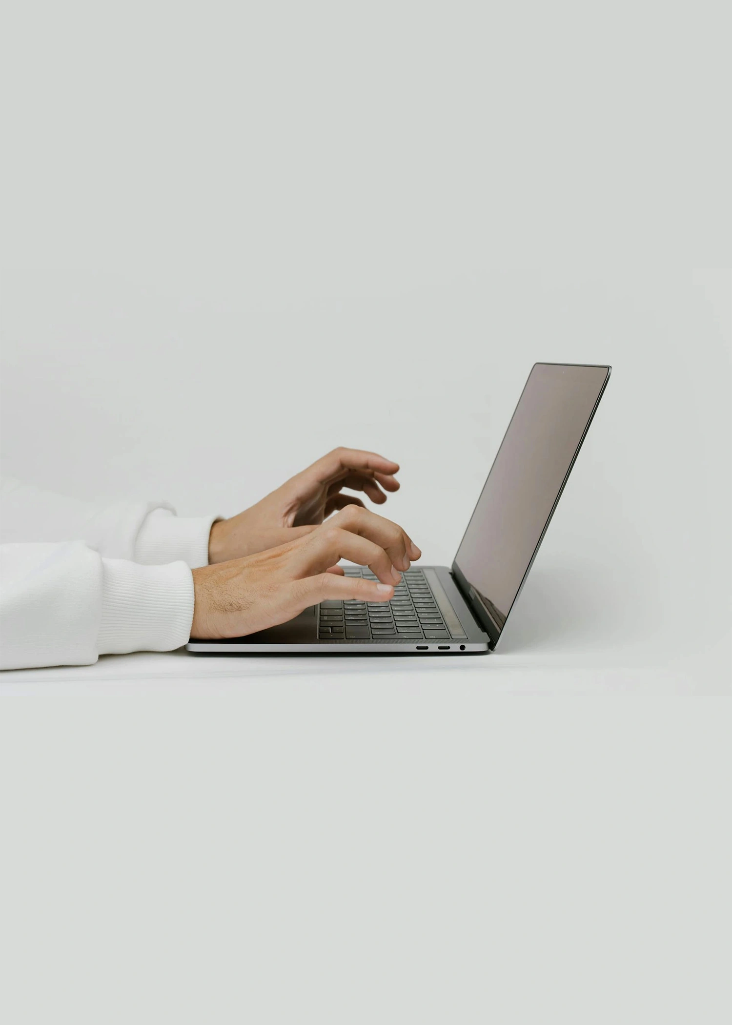Arms of a person using a laptop